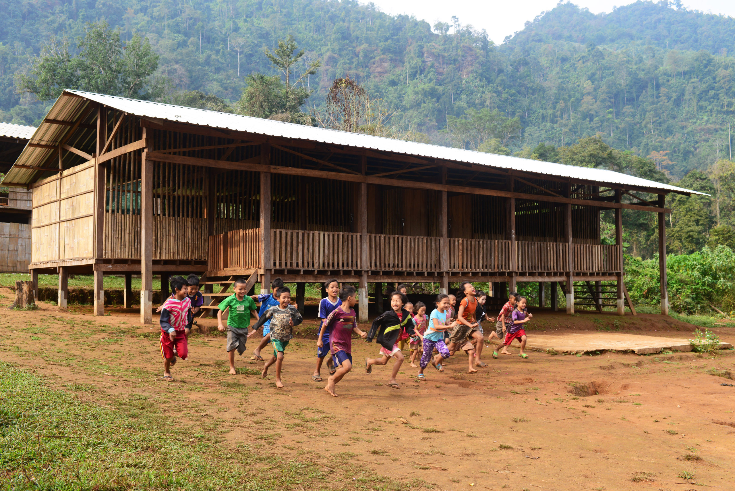 Children running in front of Klay Poe Klo Primary School. Klay Poe Klo Primary school is the first project designed for Gyaw Gyaw by Jae-Young Lee. The first phase contains of two classrooms and a library. It is a timber building with bamboo walls. The design is based on traditional Karen techniques and materials but strengthened and given a functional and climate adjusted design for better use over time. Photograph by Vincenzo Floramo