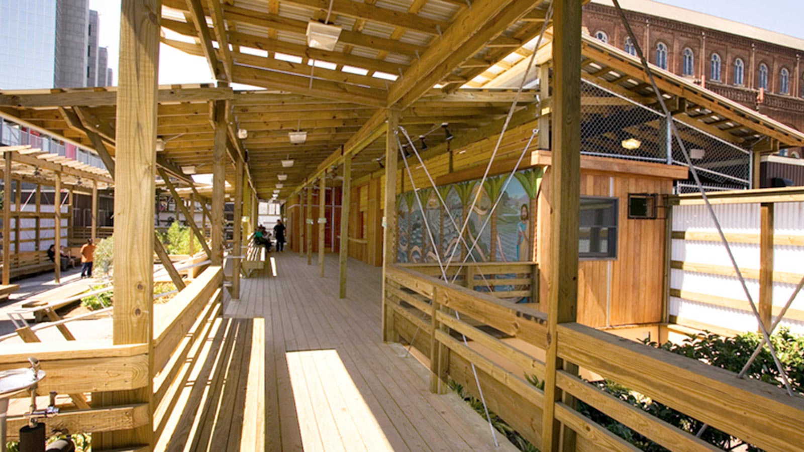 The design of the St Joseph Rebuild Center utilizes six trailers connected by urban outdoor space or plaza used for gathering.