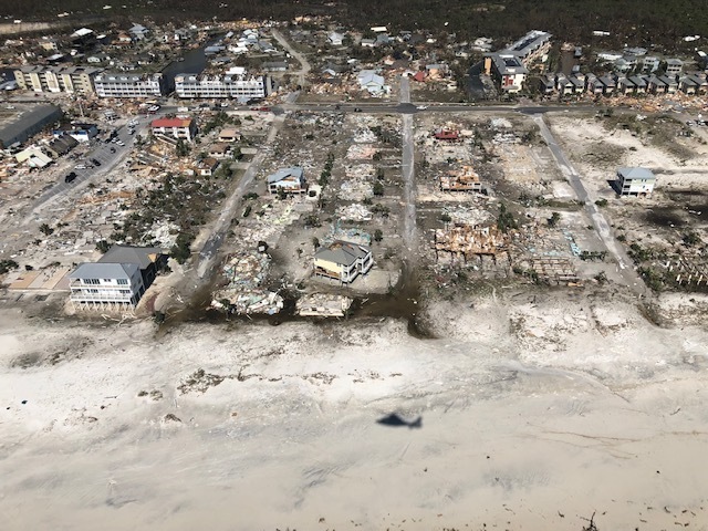 A Coast Guard MH-65 Dolphin aircrew from Air Station Miami assesses the damage of Mexico Beach, Florida, from Hurricane Michael, Oct. 11, 2018. After a storm passes, the Coast Guard focuses on saving lives in the impacted area and responds to hazardous environmental threats. (U.S. Coast Guard photo by Petty Officer 1st Class Colin Hunt)